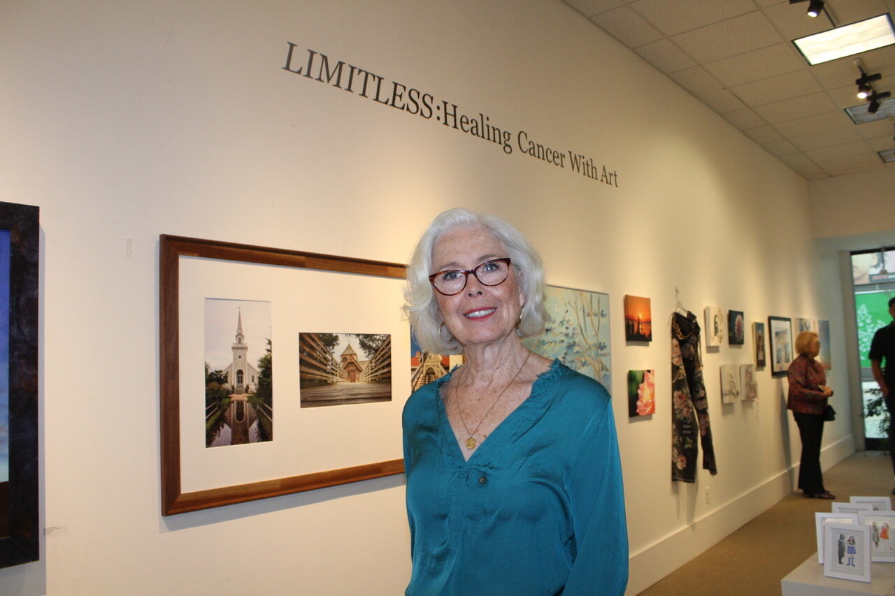 Cancer survivor Belinda Rubino stands before her photography creation, “Steeples,” at the Islip Arts Council gallery.